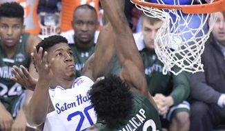 Seton Hall forward Desi Rodriguez (20) attempts to dunk the ball over Manhattan forward Pauly Paulicap (33) during the first half of an NCAA college basketball game, Saturday, Dec. 23, 2017, in Newark, N.J. (AP Photo/Bill Kostroun)