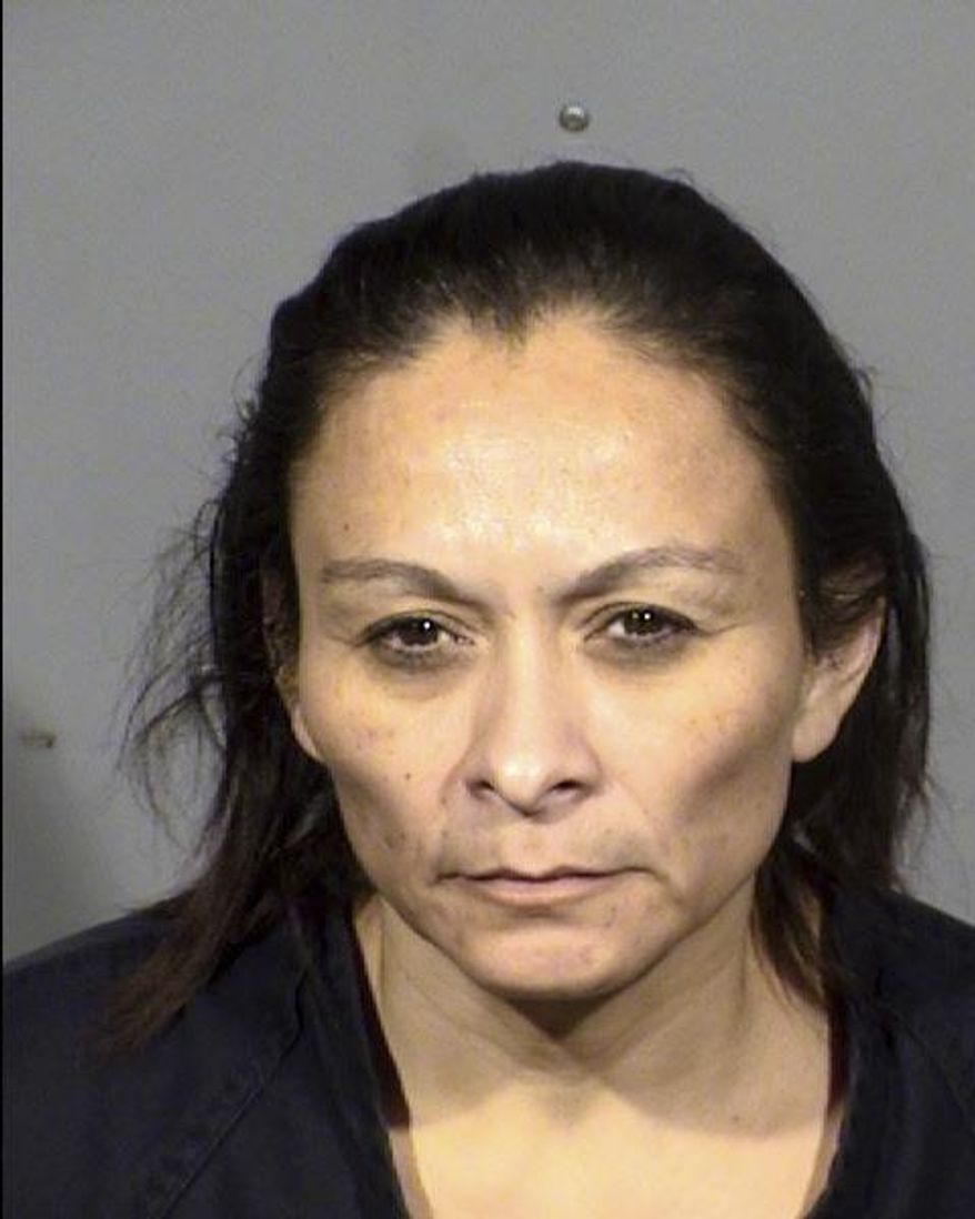 This booking photo provided by Las Vegas Metropolitan Police Department on Saturday, Dec. 23, 2017 shows Christine Sanchez, 47. Sanchez is accused of fatally shooting her three roommates on Dec. 22. (Las Vegas Metropolitan Police Department via The AP)