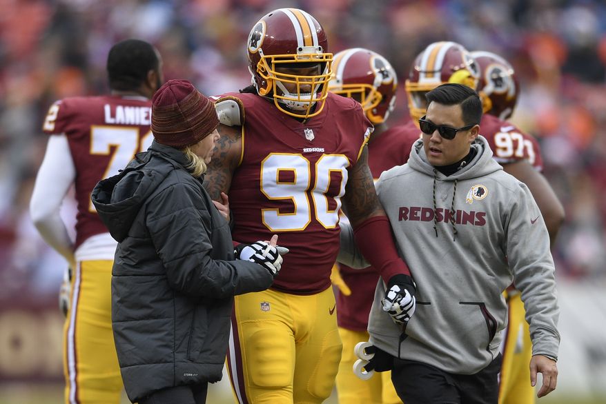 Washington Redskins nose tackle Ziggy Hood (90) is helped from the filed after an injury during the first half an NFL football game against the Denver Broncos in Landover, Md., Sunday, Dec 24, 2017. (AP Photo/Nick Wass)