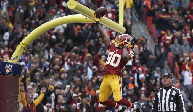 Washington Redskins wide receiver Jamison Crowder (80) celebrates his touchdown by dunking the ball over the goal posts during the first half an NFL football game against the Denver Broncos in Landover, Md., Sunday, Dec 24, 2017. (AP Photo/Alex Brandon) **FILE**