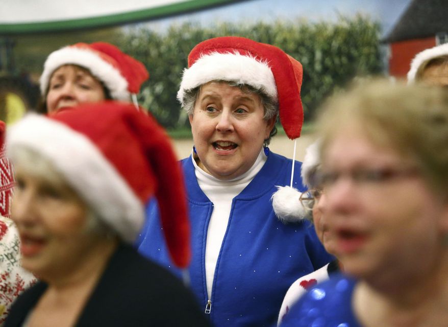 Sara Stone, center, sings holiday tunes with Harmony Magic, a central Indiana women's barbershop chorus on Dec. 7, 2017, at Tipton County Chamber of Commerce's Holiday Reception. (Kelly Lafferty Gerber/The Kokomo Tribune via AP)