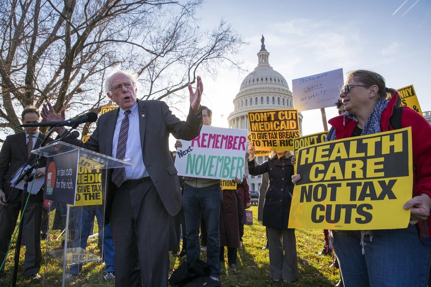 FILE - In this Thursday, Nov. 30, 2017, file photo, Sen. Bernie Sanders, I-Vt., joins protesters outside the Capitol as Republicans in the Senate work to pass their sweeping tax bill, a blend of generous tax cuts for businesses and more modest tax cuts for families and individuals, on Capitol Hill in Washington. (AP Photo/J. Scott Applewhite, File)