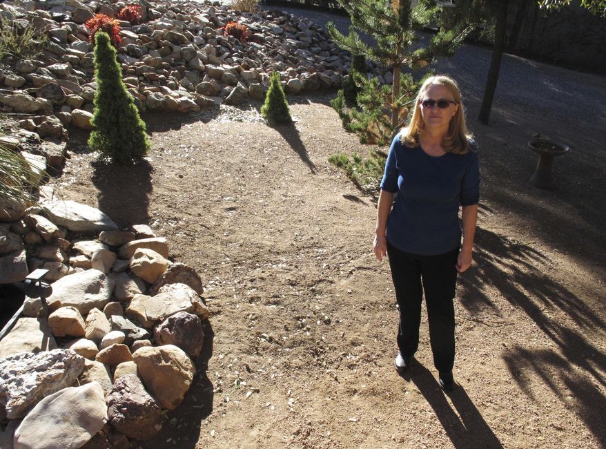 In this Friday, Dec. 15, 2017 photo, Debbie Neckel poses at her home. Neckel was the lead detective in a 2008 case in St. Johns, Arizona, where an 8-year-old boy was accused of killing his father and his father's friend. The boy, who pleaded guilty to a negligent homicide charge, is nearing the end of probation. (AP Photo/Felicia Fonseca)