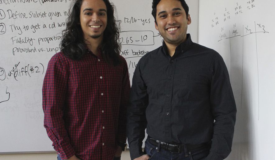 In this Wednesday, Dec. 13, 2017, photo, Yale graduate students Michael Lopez-Brau, left, and Stefan Uddenberg pose at Yale University in New Haven, Conn. The pair helped create an internet browser extension, &amp;quot;Open Mind,&amp;quot; with students from Cal Tech and Waterloo University. The extension is designed to flag fake and biased news stories and provide the reader with alternatives. (AP Photo/Pat Eaton-Robb)