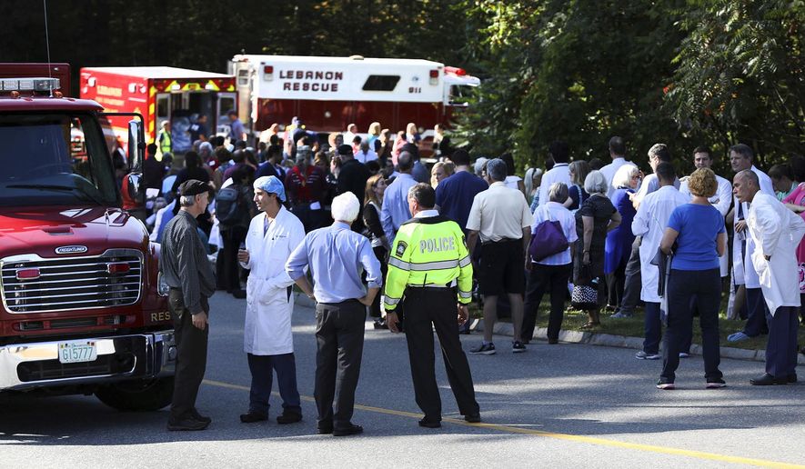 FILE-- In this Sept. 12, 2017 file photograph selected as part of New Hampshire's top stories and images of 2017, first responders, doctors, staff, patients, their family members and others wait near the main entrance of Dartmouth Hitchock Medical Center during an active shooter incident at the medical center in Lebanon, N.H. A family member shot and killed a 70-year-old female patient in the Intensive Care Unit earlier in the afternoon. A man who fatally shot his mother in New Hampshire's largest hospital, debate over election fraud and whether communities should allow keno to raise money for full-day kindergarten topped state news headlines in 2017. (Charles Hatcher/The Valley News via AP)
