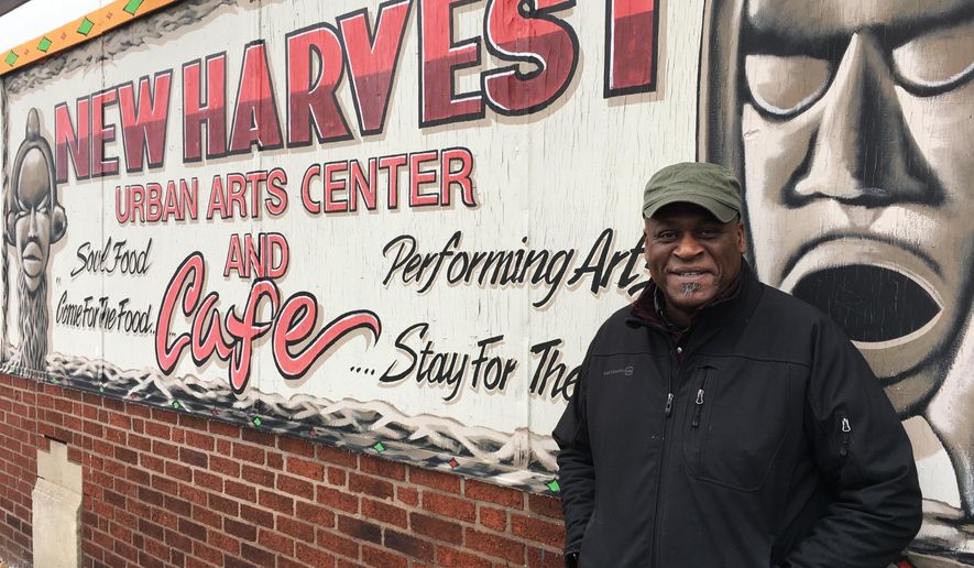 In this Monday, Dec. 18, 2017, photo, Columbus community activist Kwodwo Ababio stands outside his New Harvest Urban Arts Center and Cafe in Columbus, Ohio. The city's soaring homicide rate hit home for Ababio recently when a former foster son was shot and killed. (AP Photo/Andrew Welsh-Huggins)