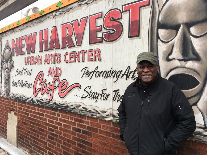 In this Monday, Dec. 18, 2017, photo, Columbus community activist Kwodwo Ababio stands outside his New Harvest Urban Arts Center and Cafe in Columbus, Ohio. The city's soaring homicide rate hit home for Ababio recently when a former foster son was shot and killed. (AP Photo/Andrew Welsh-Huggins)