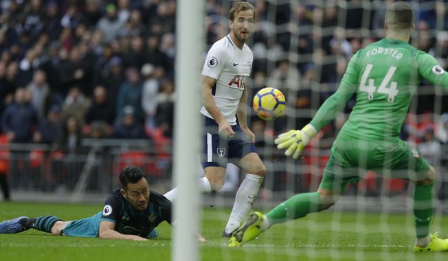 Tottenham Hotspur&#x27;s Harry Kane watches as he scores his sides 5th goal and his third of the game during their English Premier League soccer match between Tottenham Hotspur and Southampton at Wembley stadium in London Tuesday, Dec 26 2017. (AP Photo/Alastair Grant)