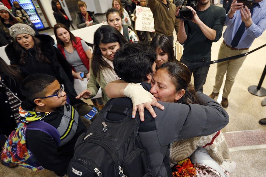 In this Monday, Dec. 25, 2017 photo, Maria Santiago Garcia, right, receives a hug before going through security gate at the Salt Lake City International Airport. Garcia, a Guatemalan woman facing deportation spent Christmas night at Salt Lake City's airport before flying back to her native country with her four young children after months of failed efforts to win her a reprieve to stay in the U.S. About 20 friends and supporters came to the airport to send the family off. (AP Photo/Rick Bowmer)