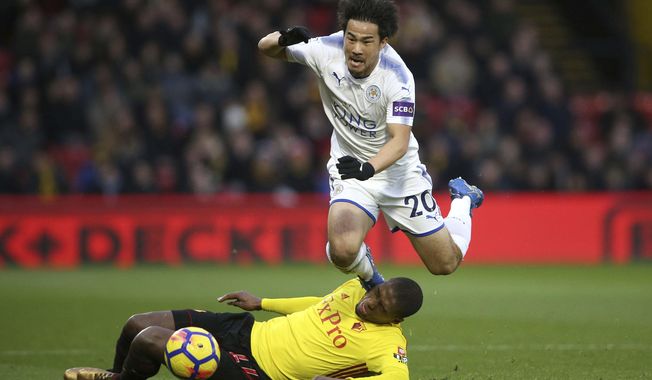 Leicester City&#x27;s Shinji Okazaki, top, is challenged by Watford&#x27;s Christian Kabasele during the English Premier League soccer match at Vicarage Road, Watford, England, Tuesday, Dec. 26, 2017. (Scott Heavey/PA via AP)