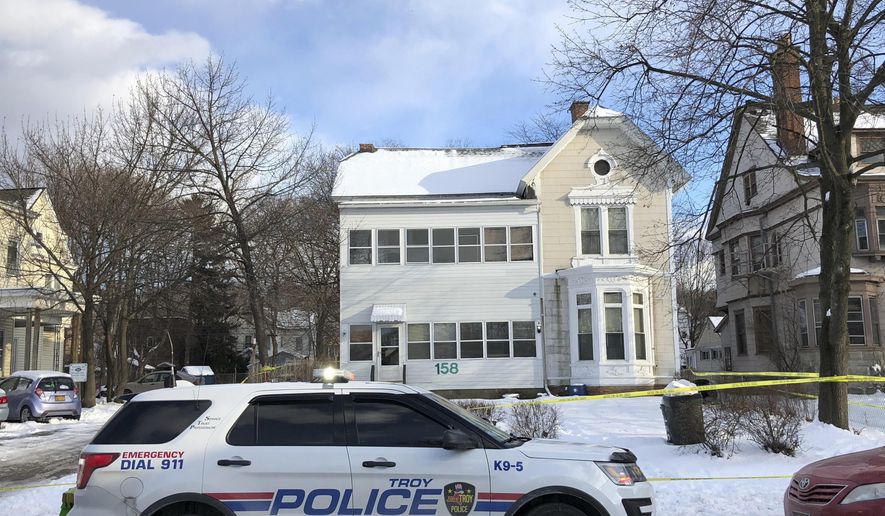 Police secure the perimeter of a home in Troy, N.Y., Tuesday, Dec. 26, 2017, after four bodies were discovered in a basement apartment. Troy police say the deaths are being treated as suspicious. (Nicholas Buonanno/The Record via AP)