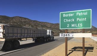 In this Thursday, Dec. 14, 2017 photo, a sign warns of the upcoming California Pine Valley checkpoint, on the main route from Arizona to San Diego. (AP Photo/Elliot Spagat) **FILE**