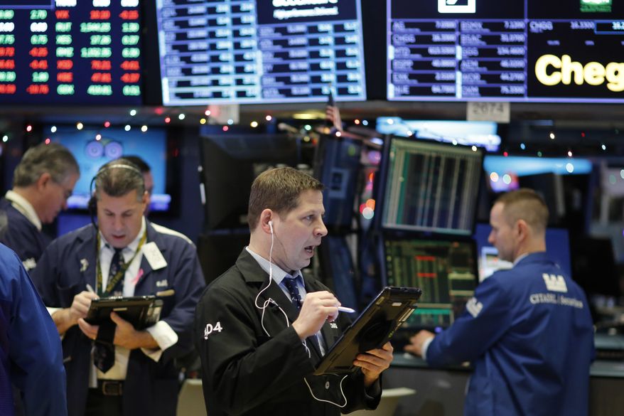 Traders work at the New York Stock Exchange, Wednesday, Dec. 27, 2017. (AP Photo/Mark Lennihan) ** FILE **