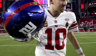 New York Giants quarterback Eli Manning (10) leaves the field after an NFL football game against the Arizona Cardinals, Sunday, Dec. 24, 2017, in Glendale, Ariz. The Cardinals won 23-0. (AP Photo/Rick Scuteri)