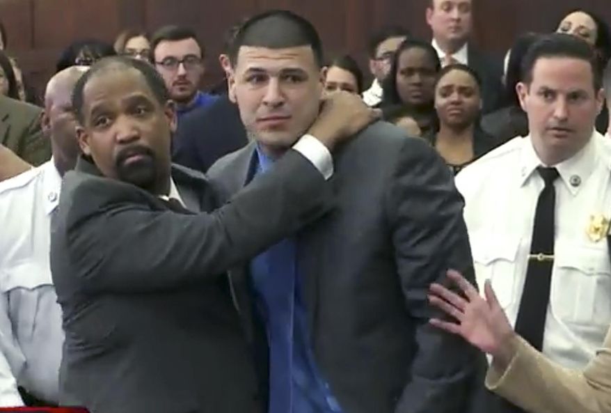 File - In this April 14, 2017 file still image from video, Aaron Hernandez, center, is hugged by defense attorney Ronald Sullivan in court in Boston, after being found not guilty of murder in the 2012 shootings of two men in a drive-by shooting in Boston. Second from right is his Shayanna Jenkins Hernandez, his fiancee. Just days later, Hernandez hanged himself in the prison cell where he was serving a life sentence for the 2013 killing of Odin Lloyd. (WHDH-TV via AP, Pool, File)