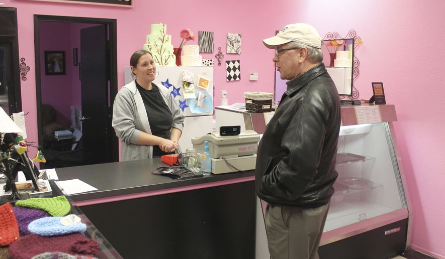 FILE - In this Feb. 5, 2013, file photo, Melissa Klein, co-owner of Sweet Cakes by Melissa, in Gresham, Ore., tells a customer that the bakery has sold out of baked goods for the day. An appellate court Thursday, Dec. 28, 2017, upheld a penalty against the bakery owners who refused to make a cake for a same-sex wedding almost five years ago. (Everton Bailey Jr./The Oregonian via AP, File)