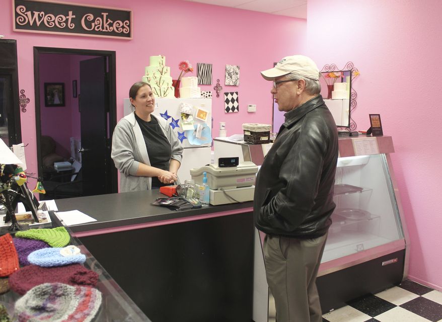 In this Feb. 5, 2013, file photo, Melissa Klein, co-owner of Sweet Cakes by Melissa, in Gresham, Ore., tells a customer that the bakery has sold out of baked goods for the day. (Everton Bailey Jr./The Oregonian via AP, File)
