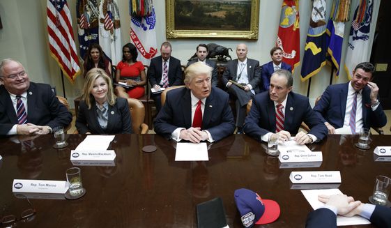 FILE - In this Feb. 16, 2017, file photo, President Donald Trump speaks during a meeting with House Republicans in the Roosevelt Room of the White House in Washington, Thursday, Feb. 16, 2017. From left are, Rep. Billy Long, R-Mo., Rep. Marsha Blackburn, R-Tenn., Trump, Rep. Chris Collins, R-N.Y., and Rep. Duncan Hunter, R-Calif. Trumps unpredictable, pugnacious approach to the presidency often worked against him as Republicans navigated a tumultuous but ultimately productive year in Congress. (AP Photo/Evan Vucci, File)