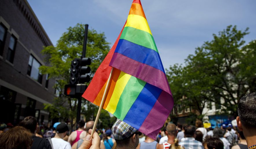 FILE - In this June 11, 2017 file photo people attend the LGBTQ Chicago Equality rally in the Andersonville neighborhood of Chicago. Starting in January 2018, Illinois is outlawing a rare criminal defense argument allowing the use of a victim&#x27;s sexual orientation as justification for violent crime. It&#x27;s a ban that gay rights advocates hope to replicate in about half a dozen states next year. Illinois follows California in outlawing the so-called &amp;quot;gay panic defense.&amp;quot; It isn&#x27;t common, but one study shows it&#x27;s surfaced in roughly half of U.S. states since the 1960s. (Brian Cassella/Chicago Tribune via AP File)