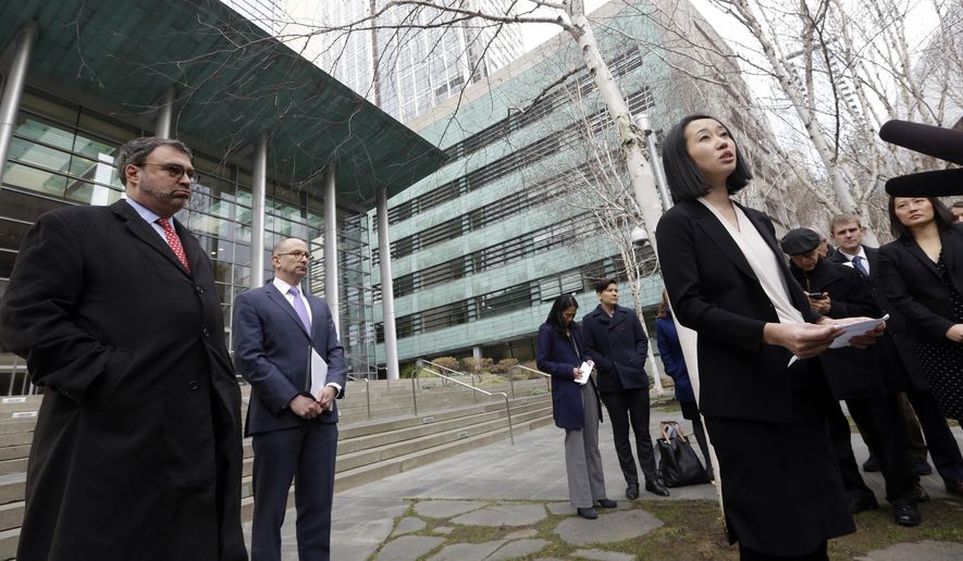 FILE- In this Dec. 21, 2017, file photo, Mariko Hirose, right, a litigation director at the Urban Justice Center, addresses reporters as Mark Hetfield, president & CEO of HIAS, left, and Rabbi Will Berkowitz, Jewish Family Service of Seattle CEO, look on in front of a federal courthouse after speaking with media in Seattle. The government has asked a federal judge to change his order that partially lifted a Trump administration refugee ban. (AP Photo/Elaine Thompson, File)