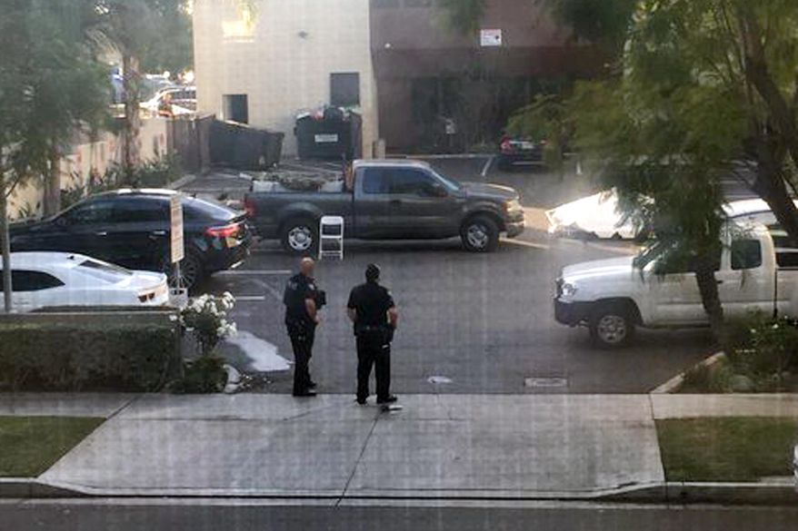 This photo provided by Basileus Zeno shows police at the scene of an active shooting in Long Beach, Calif. Friday, Dec. 29, 2017. Police say there are multiple victims at the scene but nothing about the number or their conditions. (Basileus Zeno via AP)