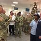 FILE - In this Dec. 22, 2017, file photo, Lt. Gen. Stephen Townsend takes a photo of Defense Secretary Jim Mattis and a dining facility worker at Fort Bragg, N.C. For only the second time since 9/11, America’s defense secretary didn’t visit U.S. troops in a war zone during December, breaking a longstanding tradition of personally and publicly thanking service members in combat who are separated from their families during the holiday season. (AP Photo/Robert Burns, File)