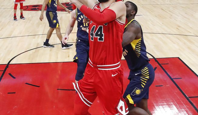 Chicago Bulls forward Nikola Mirotic, center, goes to the basket against Indiana Pacers forward Alex Poythress, right, during the first half of an NBA basketball game, Friday, Dec. 29, 2017, in Chicago. (AP Photo/Kamil Krzaczynski)