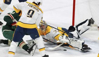 Minnesota Wild&#39;s Mikael Granlund (64), of Finland, is denied at the goal by Nashville Predators Pekka Rinne (35), of Finland, in front of Filip Forsberg (9), of Sweden, during the second period of an NHL hockey game on Friday, Dec. 29, 2017, in St. Paul, Minn. (AP Photo/Andy Clayton-King)