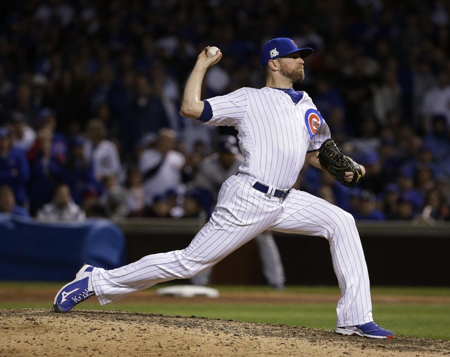 FILE - In this Wednesday, Oct. 18, 2017, file photo, Chicago Cubs relief pitcher Wade Davis throws during the ninth inning of Game 4 of baseball&#39;s National League Championship Series against the Los Angeles Dodgers, in Chicago. The Colorado Rockies added a significant piece to what’s becoming a formidable and high-priced bullpen by agreeing to a three-year, $52 million contract with All-Star reliever Wade Davis, a person familiar with the negotiations told The Associated Press, on Friday, Dec. 29. (AP Photo/Nam Y. Huh, File)
