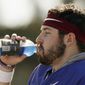 Oklahoma quarterback Baker Mayfield takes a breather after he participated in drills during a short segment of Rose Bowl practice that was open to the media Friday, Dec. 29, 2017, in Carson, Calif. Oklahoma plays Georgia in a semifinal of the College Football Playoff on New Year&#x27;s Day. (Bob Andres/Atlanta Journal-Constitution via AP)