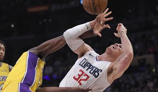 Los Angeles Clippers forward Blake Griffin, right, tangles with Los Angeles Lakers forward Julius Randle as Griffin shoots during the first half of an NBA basketball game Friday, Dec. 29, 2017, in Los Angeles. (AP Photo/Mark J. Terrill)