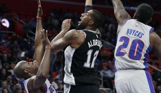 San Antonio Spurs forward LaMarcus Aldridge (12) shoots over Detroit Pistons forward Anthony Tolliver (43) and guard Dwight Buycks (20) during the first half of an NBA basketball game, Saturday, Dec. 30, 2017, in Detroit. (AP Photo/Carlos Osorio)