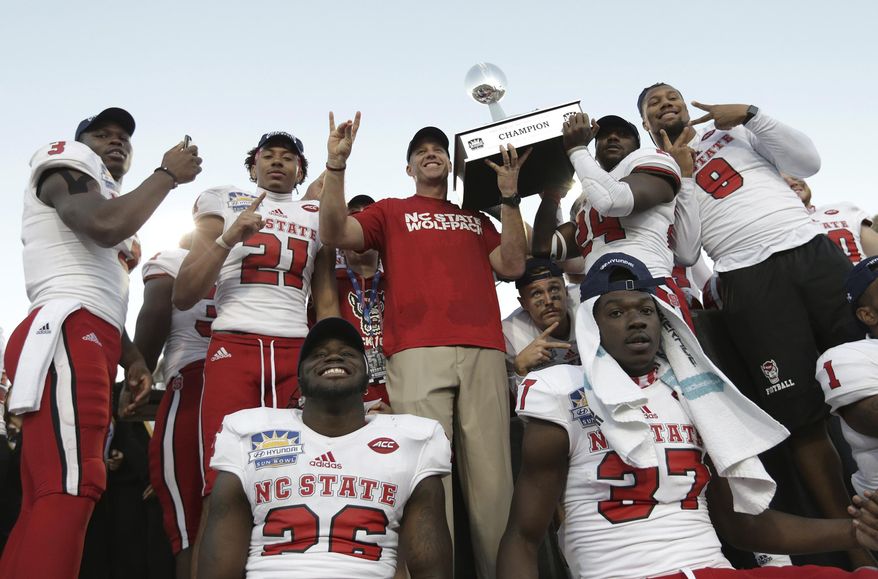North Carolina State celebrates with the Hyundai Sun Bowl trophy after defeating Arizona State 52-31 in the NCAA college football game Friday, Dec. 29, 2017, in El Paso, Texas. (Mark Lambie/The El Paso Times via AP)