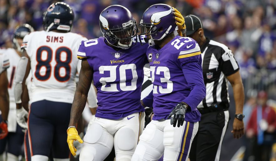 Minnesota Vikings cornerback Mackensie Alexander (20) celebrates with teammate Terence Newman (23) during the second half of an NFL football game against the Chicago Bears, Sunday, Dec. 31, 2017, in Minneapolis. (AP Photo/Bruce Kluckhohn)