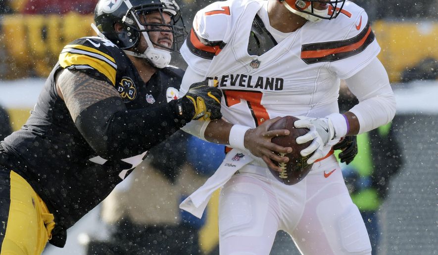 Cleveland Browns quarterback DeShone Kizer (7) is sacked by Pittsburgh Steelers defensive end Tyson Alualu (94) during the first half of an NFL football game in Pittsburgh, Sunday, Dec. 31, 2017. (AP Photo/Don Wright)