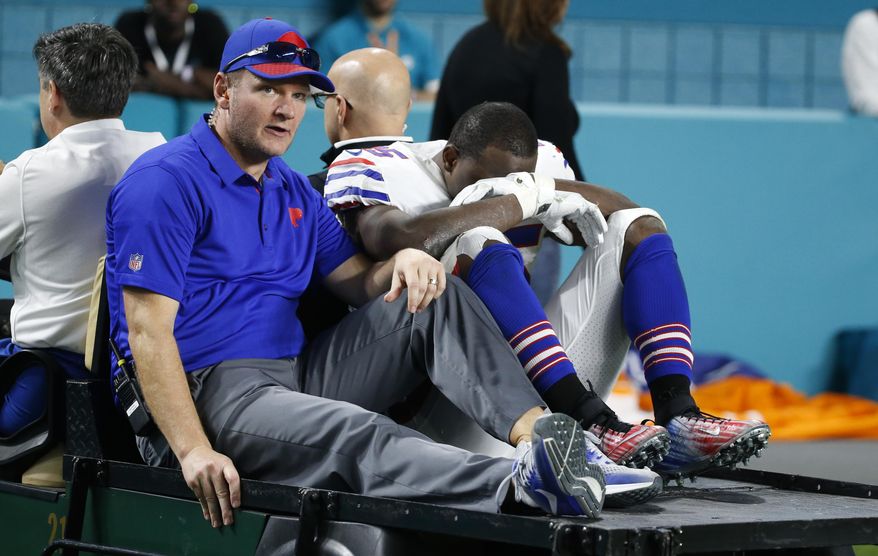 Buffalo Bills running back LeSean McCoy (25) is driven off the field after he was injured on a play, during the second half of an NFL football game against the Miami Dolphins, Sunday, Dec. 31, 2017, in Miami Gardens, Fla. (AP Photo/Wilfredo Lee)
