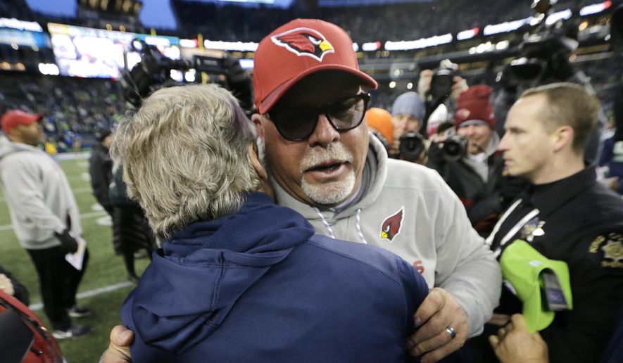 Arizona Cardinals head coach Bruce Arians, front right, hugs Seattle Seahawks head coach Pete Carroll, left, after an NFL football game, Sunday, Dec. 31, 2017, in Seattle. (AP Photo/John Froschauer) **FILE**