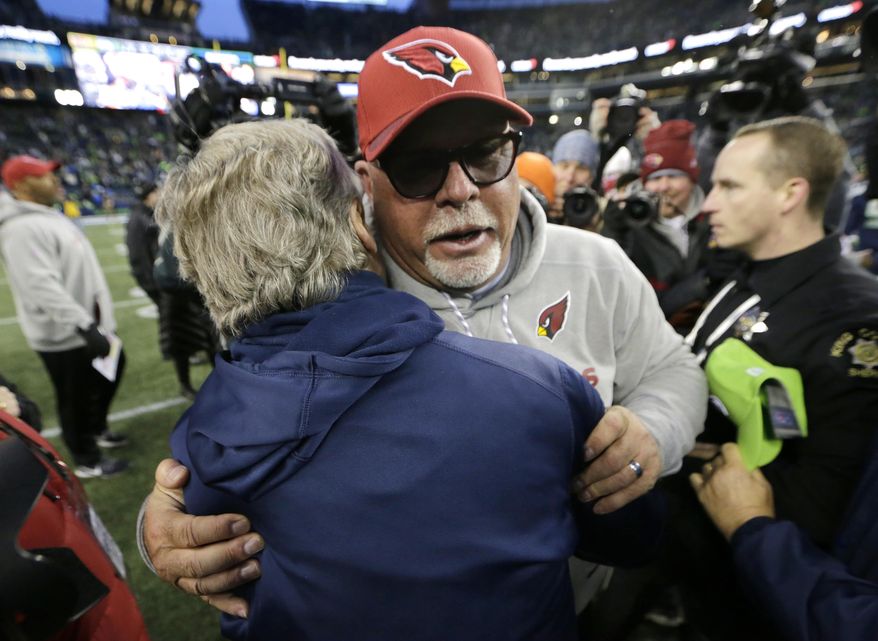 Arizona Cardinals head coach Bruce Arians, front right, hugs Seattle Seahawks head coach Pete Carroll, left, after an NFL football game, Sunday, Dec. 31, 2017, in Seattle. (AP Photo/John Froschauer) **FILE**