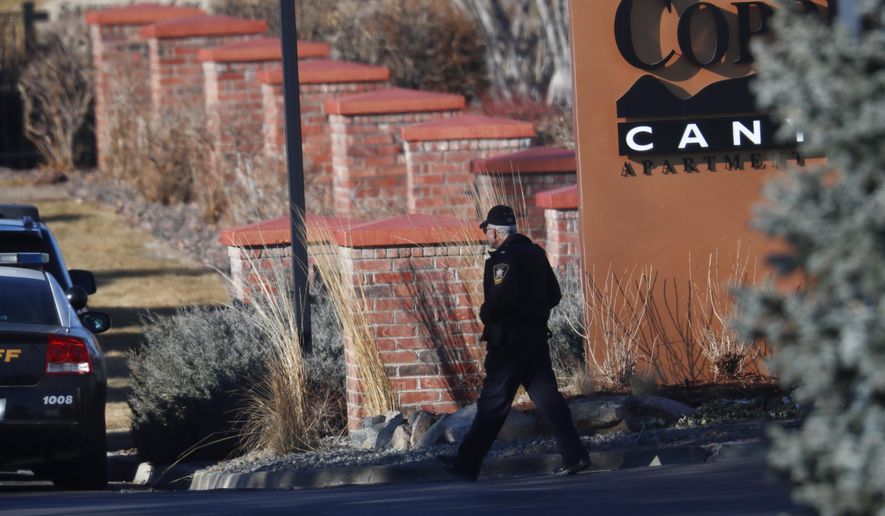 An investigator heads to the scene of shooting Sunday, Dec. 31, 2017, in Highlands Ranch, Colo. Authorities in Colorado say one deputy has died and multiple others were wounded, along with two civilians, in a shooting that followed a domestic disturbance in suburban Denver. (AP Photo/David Zalubowski)