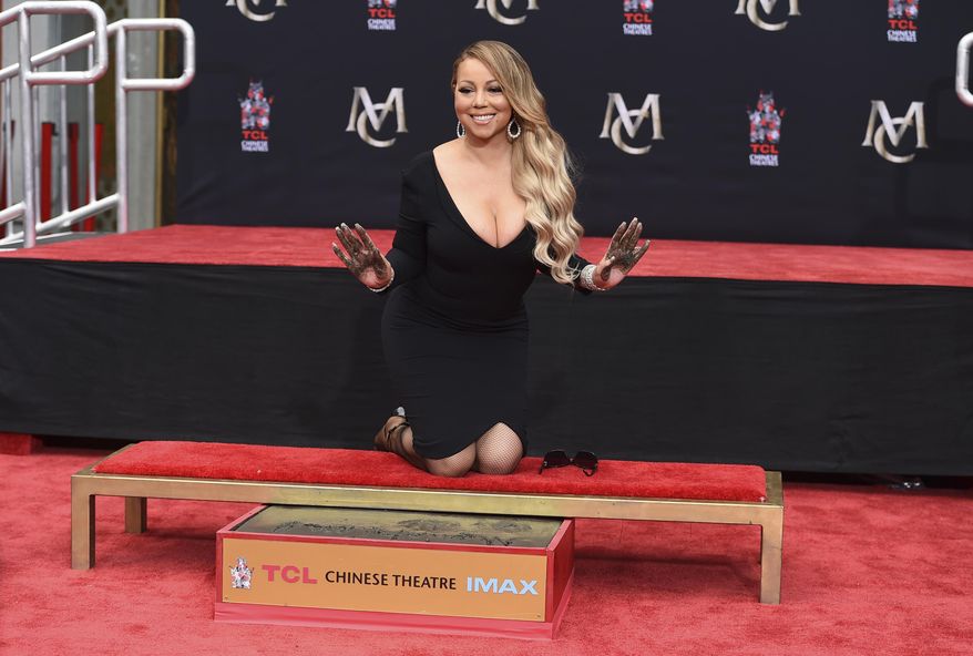 FILE - In this Wednesday, Nov. 1, 2017, file photo, Mariah Carey poses for photographers during her hand and footprint ceremony at the TCL Chinese Theatre in Los Angeles. Carey will perform again Sunday, Dec. 31, 2017, on &amp;quot;Dick Clark&#39;s New Year&#39;s Rockin&#39; Eve,&amp;quot; hosted by Ryan Seacrest, after a bungled performance last year in which she stumbled through her short set, failing to sing for most of it despite a pre-recorded track of her songs playing in the background. (Photo by Jordan Strauss/Invision/AP, File)