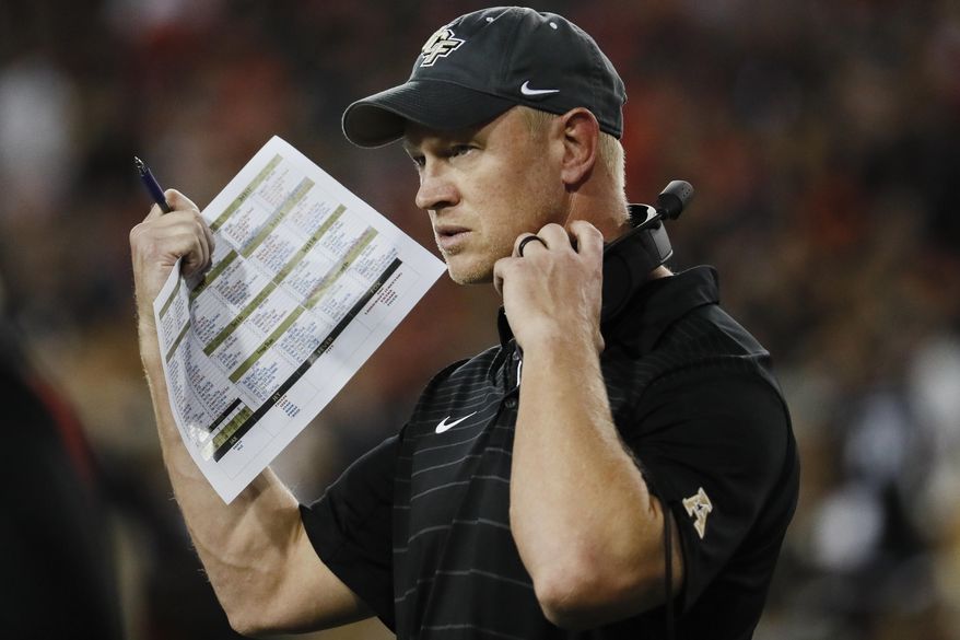 FILE - In this Oct. 7, 2017, file photo, UCF head coach Scott Frost works the sidelines in the first half of an NCAA college football game against Cincinnati, in Cincinnati. No. 10 Central Florida will by playing for a perfect season and respect for the team and its conference, when it faces No. 7 Auburn in the Peach Bowl on Monday, Jan 1, 2018. (AP Photo/John Minchillo, File)