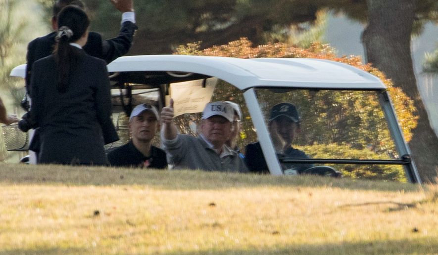 President Trump has played golf twice with Japanese Prime Minister Shinzo Abe (right) and 39 confirmed rounds overall in his first year in office. (Associated Press)