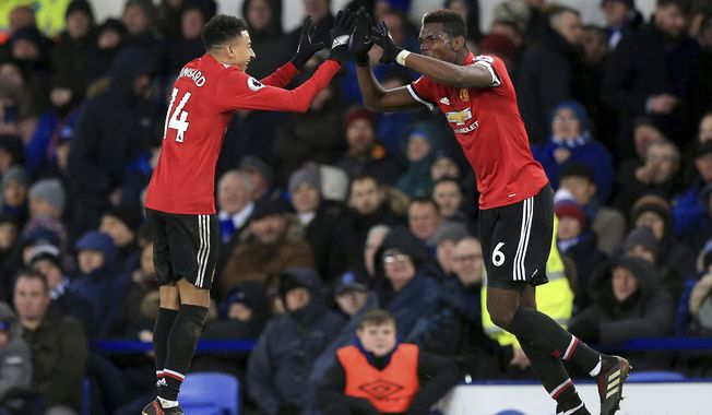 Manchester United&#x27;s Jesse Lingard, left celebrates scoring his side&#x27;s second goal of the game, during the English Premier League soccer match between Everton and Manchester United, at Goodison Park, in Liverpool, England, Monday, Jan. 1, 2018. (Peter Byrne/PA via AP)