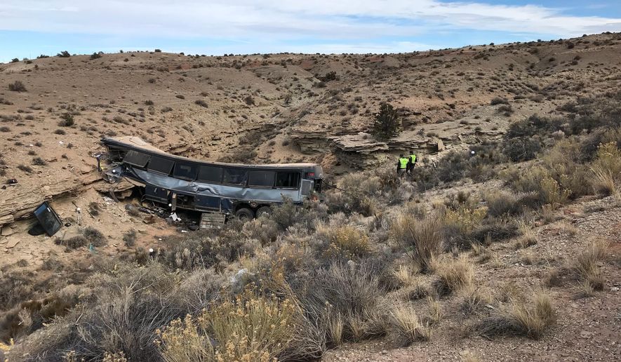 The aftermath of a late-Sunday Greyhound bus crash is seen on Monday, Jan. 1, 2018 in Emery County. A 13-year-old girl died and 11 others were hospitalized when the bus went off the freeway and crashed into a steep wash. (Ben Tidswell/The Deseret News via AP)