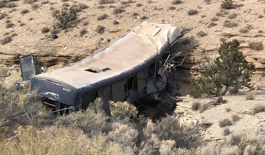 The aftermath of a late-Sunday Greyhound bus crash is seen on Monday, Jan. 1, 2018 in Emery County. A 13-year-old girl died and 11 others were hospitalized when the bus went off the freeway and crashed into a steep wash. (Ben Tidswell/The Deseret News via AP)