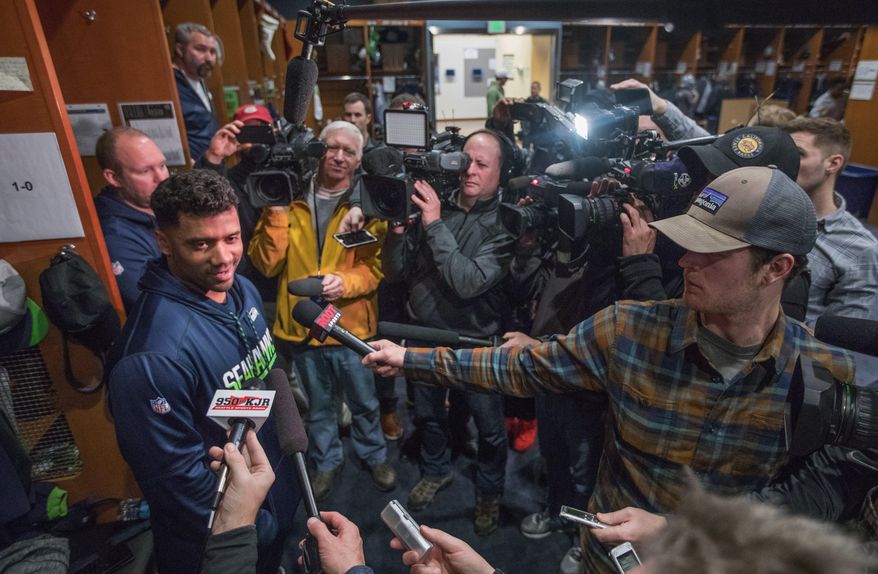Seahawks quarterback Russell Wilson answers questions a day after the last game of the season in the Seahawks locker room as other players clean out their lockers on Monday, Jan. 1, 2018. (Steve Ringman /The Seattle Times via AP)