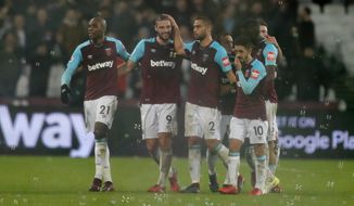 West Ham&#x27;s Andy Carroll, second from left, celebrates with teammates after scoring his side&#x27;s second goal during the English Premier League soccer match between West Ham and West Bromwich Albion at London Stadium in London, Tuesday, Jan. 2, 2018.(AP Photo/Frank Augstein)