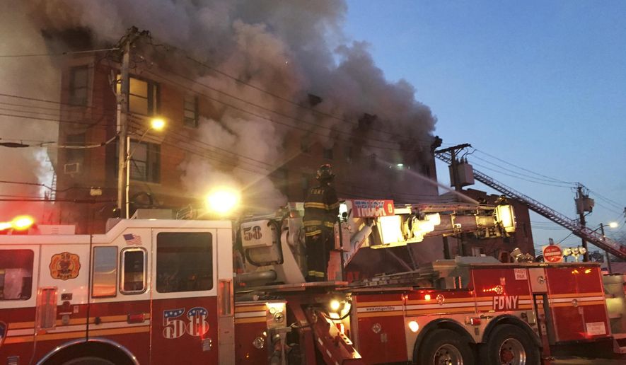 In this photo provided by the FDNY, firefighters battle a blaze at a building in the Bronx borough of New York, Tuesday, Jan. 2, 2018. (FDNY via AP)