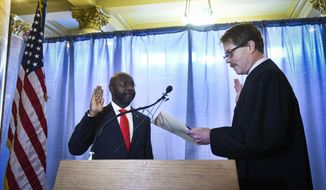 Helana&#39;s new Mayor Wilmot Collins, left, is sworn into office by Judge Mike Menahan, Tuesday morning, Jan. 2, 2018, in the Capitol Rotunda in Helena, Mont. Collins is a Liberian refugee who was elected mayor of Helena in November. (Thom Bridge/Independent Record via AP)