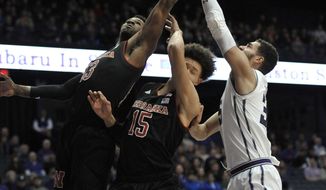 Northwestern&#x27;s Aaron Falzon (35) and Nebraska&#x27;s Anton Gill (13) and Isaiah Roby (15) reach for a rebound during the first half of an NCAA college basketball game Tuesday, Jan. 2, 2018, in Rosemont, Ill. (AP Photo/Paul Beaty)